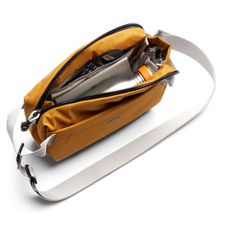 Bellroy Lite Sling Mini in mustard with adjustable strap and organized internal compartments