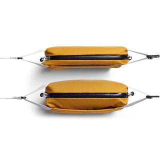 Bellroy Lite Sling Mini in ochre yellow showing top and side views with black zipper and white straps