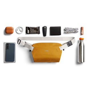 Bellroy Lite Sling Mini in mustard with white adjustable straps and compact durable design