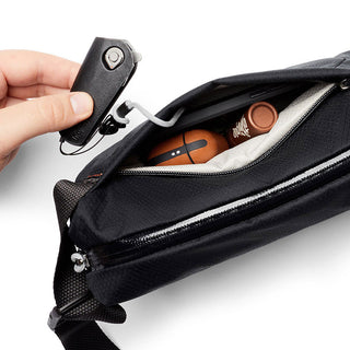Bellroy Lite Sling Mini black crossbody bag made from recycled materials showing interior storage details