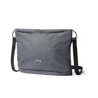 Bellroy Lite Sacoche crossbody bag in grey grid pattern with adjustable black strap and compact design