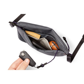 Bellroy Lite Sacoche in gray recycled fabric showing organized interior with key clip and accessories inside