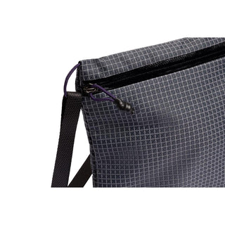 Bellroy Lite Sacoche crossbody bag in dark fabric with grid pattern and black zipper detail