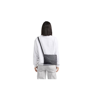 Bellroy Lite Sacoche in black recycled fabric worn crossbody by person facing away