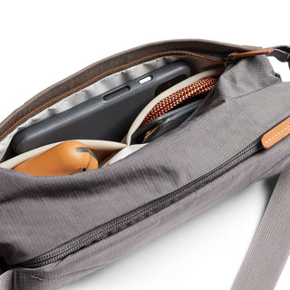 Bellroy Sling Mini Premium - 7L in gray woven fabric with leather accents showing organized interior pockets