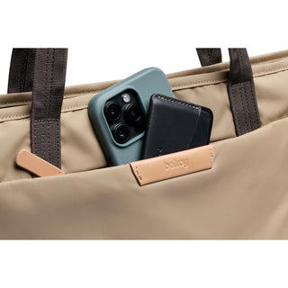 Bellroy Tokyo Tote Second Edition with tan water-resistant fabric and front pocket holding phone and wallet