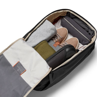 Bellroy Transit Workpack 20L open showing organized clothes and accessories in black fabric compartment