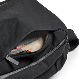 Bellroy Transit Workpack 20L black fabric backpack partially unzipped showing interior compartments and items