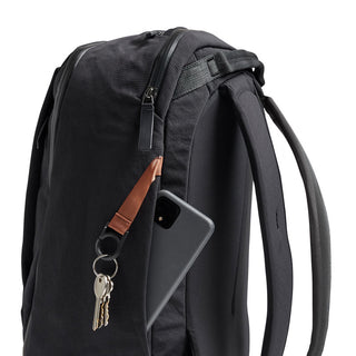 Bellroy Transit Workpack 20L black backpack with leather key strap and side zippered pocket holding a phone