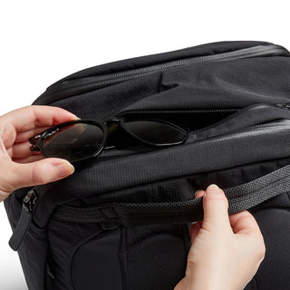 Bellroy Transit Workpack 20L black fabric backpack with leather zipper detail and front pocket in use