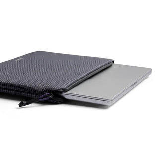 Bellroy Lite Laptop Sleeve 14" in textured navy fabric partially open with laptop inside