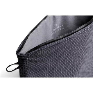 Bellroy Lite Laptop Sleeve 14" showing black grid fabric texture and partially open zippered top edge