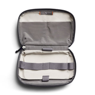 Bellroy Tech Kit open showing gray fabric interior with multiple elastic straps and organized compartments