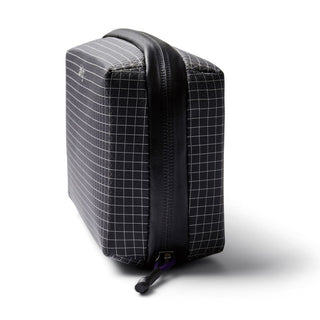 Bellroy Tech Kit black grid pattern with durable fabric and sturdy zipper closure shown from side angle