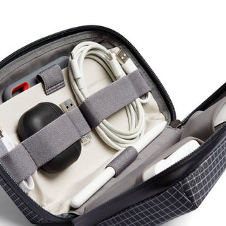 Bellroy Tech Kit open showing organized cables and accessories secured with gray elastic straps