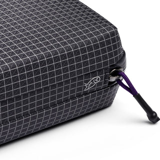 Bellroy Tech Kit close-up of black textured fabric with grid pattern and purple zipper pull detail