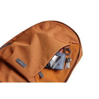 Bellroy Classic Backpack Second Edition in rust fabric with front pocket holding keys and cardholder