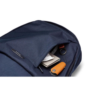 Bellroy Classic Backpack Second Edition navy blue fabric with front pocket holding keys and notebook