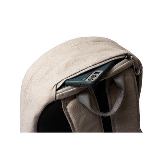 Bellroy Classic Backpack Second Edition in light beige with back zipper pocket holding a smartphone