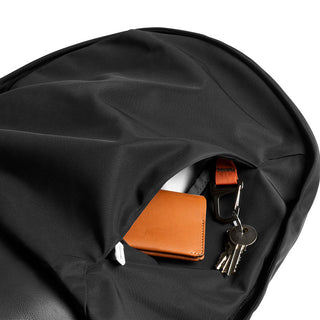 Bellroy Classic Backpack Premium in black fabric with front pocket holding wallet and key clip