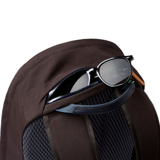 Bellroy Classic Backpack Premium with dark brown fabric and zippered top pocket holding sunglasses