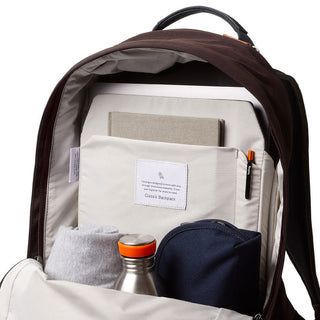 Bellroy Classic Backpack Premium open showing organized interior pockets with accessories and light fabric lining