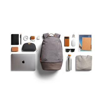 Bellroy Classic Backpack Premium in gray with brown base and everyday tech and accessories arranged around it