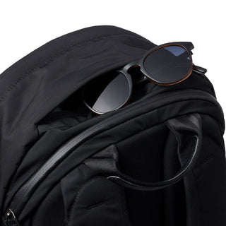 Bellroy Classic Backpack Plus Second Edition black fabric and top handle with sunglasses tucked in zipper pocket