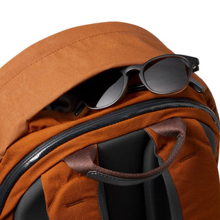 Bellroy Classic Backpack Plus Second Edition in rust fabric with sunglasses tucked in top pocket