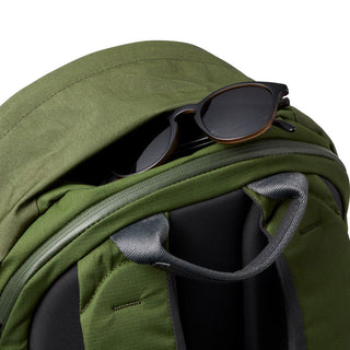 Bellroy Classic Backpack Plus Second Edition in olive green showing top handle and sunglasses in pocket