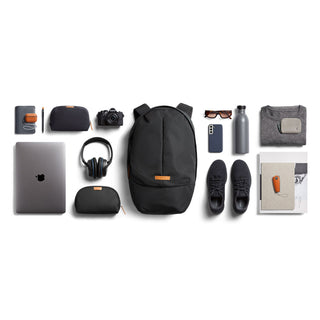 Bellroy Classic Backpack Plus Second Edition in black with organized daily essentials laid out flat