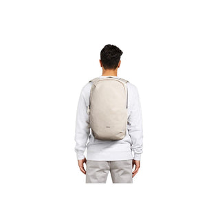 Bellroy Via Backpack worn by person, showing minimalist design and light beige recycled fabric texture
