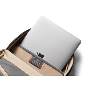 Bellroy Via Backpack in beige and gray with laptop compartment holding silver laptop