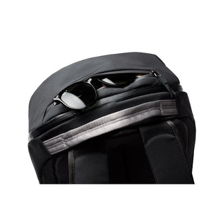 Bellroy Via Backpack in black with padded straps and sunglasses partially visible in top pocket