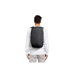 Bellroy Via Backpack worn by man, showing black sleek recycled fabric and streamlined design from back view