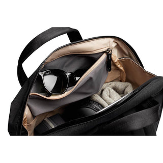 Bellroy Via Workpack open showing internal compartments with sunglasses and folded knitwear inside