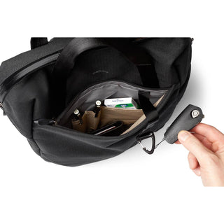 Bellroy Via Workpack open pocket showing organized interior with pens and key tether in black fabric