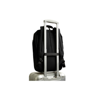 Bellroy Via Workpack black backpack secured on silver suitcase handle for travel convenience