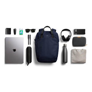 Bellroy Via Workpack navy backpack surrounded by tech essentials and daily accessories on white background