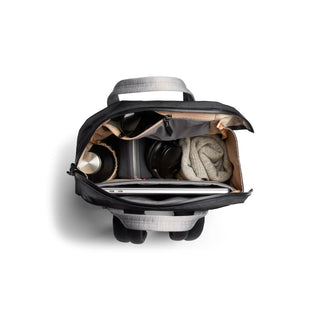 Bellroy Via Workpack top view showing organized compartments with laptop, headphones, and sweater inside