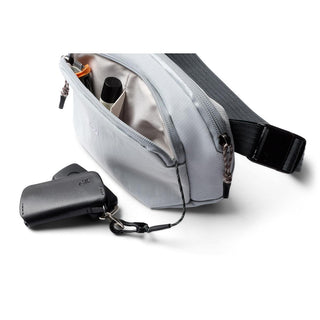 Bellroy Venture Hip Pack 1.5L in light grey recycled fabric with open main compartment and keyring attached