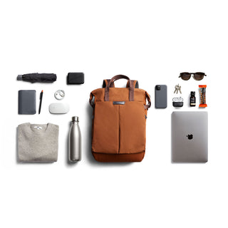 Bellroy Tokyo Totepack Compact in brown recycled nylon with organized daily carry essentials arranged nearby