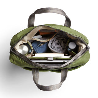 Bellroy Tokyo Totepack Compact in green showing organized interior with rolled clothes and tech accessories