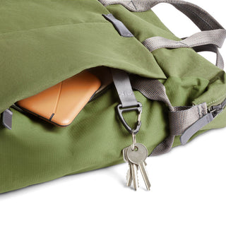 Bellroy Tokyo Totepack Compact in green fabric with external pocket holding tablet and key clip detail