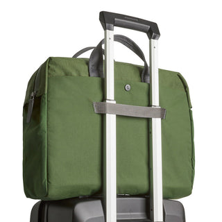 Bellroy Tokyo Work Bag in green recycled fabric secured on a suitcase handle strap