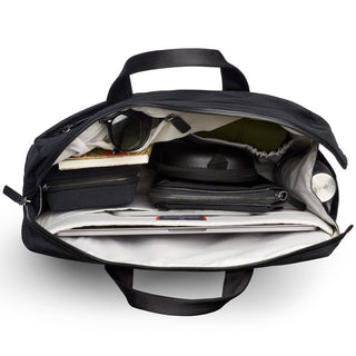 Bellroy Tokyo Work Bag open to show multiple compartments holding everyday essentials and travel items