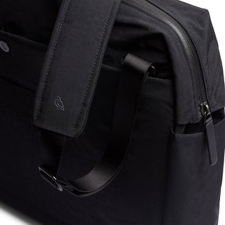 Close-up of black Bellroy Tokyo Work Bag strap and pocket crafted from recycled polyester fabric