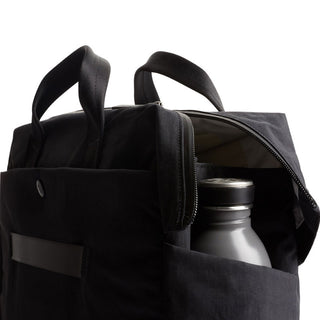 Bellroy Tokyo Work Bag in black recycled polyester with zippered main compartment open showing water bottle inside