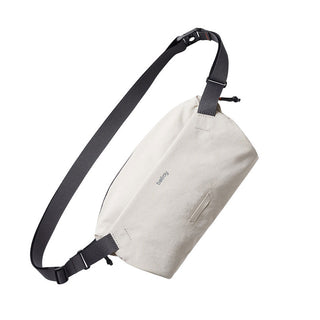 Bellroy Lite Sling in off-white made from recycled materials with adjustable black strap and minimalist design