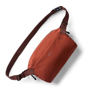 Bellroy Lite Sling in rust color with adjustable strap made from water-resistant recycled materials